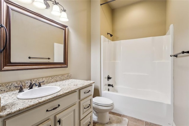 bathroom featuring toilet, tile patterned flooring, shower / washtub combination, and vanity