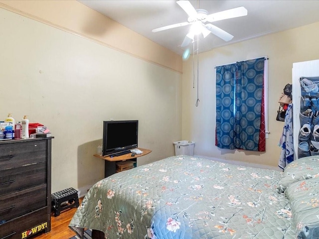 bedroom featuring a ceiling fan and wood finished floors