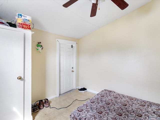bedroom with lofted ceiling, baseboards, ceiling fan, and light floors