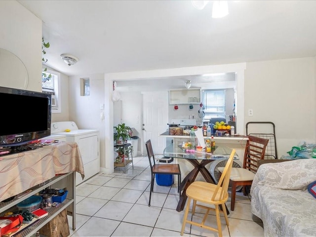 dining room with washer / dryer and light tile patterned floors