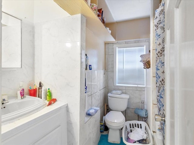 bathroom with toilet, a shower with curtain, tile walls, and vanity