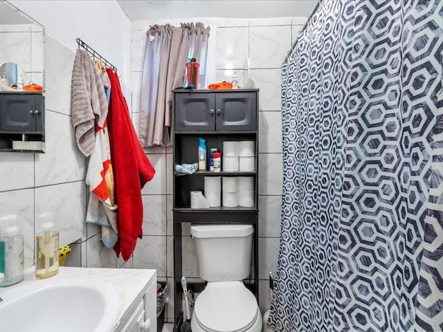 bathroom with toilet, tile walls, a shower with shower curtain, and vanity