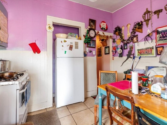 kitchen with white appliances and light tile patterned floors