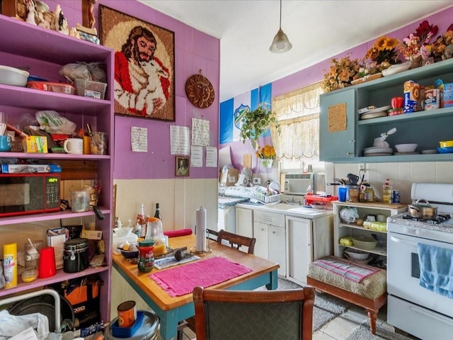 kitchen with open shelves and white range with gas stovetop