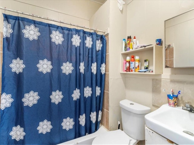 full bath featuring toilet and a sink