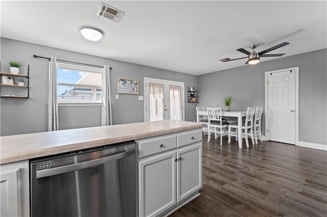 kitchen with visible vents, light countertops, french doors, stainless steel dishwasher, and dark wood-style floors