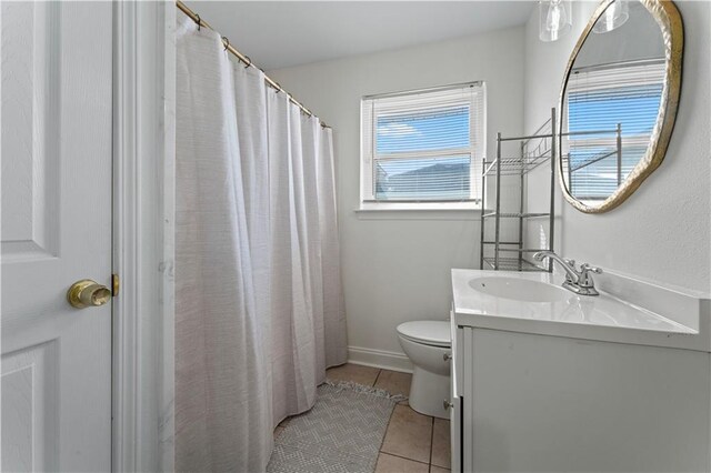 full bath with a shower with shower curtain, toilet, vanity, baseboards, and tile patterned floors