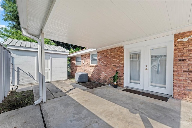 view of patio featuring a storage shed, an outdoor structure, and fence