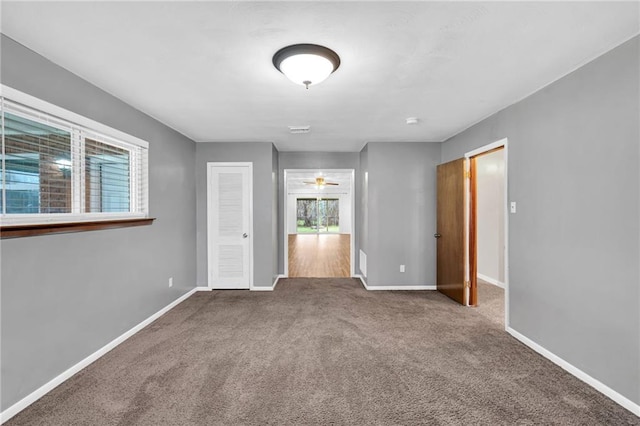 unfurnished bedroom featuring carpet, visible vents, and baseboards