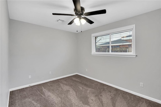 carpeted spare room with visible vents, ceiling fan, and baseboards