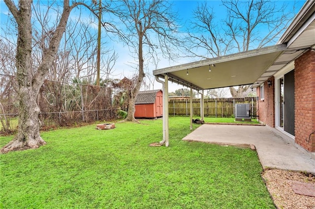 view of yard featuring a fenced backyard, an outbuilding, cooling unit, a patio area, and a shed