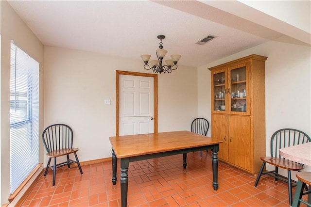 office area with a chandelier, visible vents, and baseboards