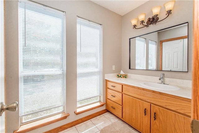 bathroom featuring vanity, baseboards, and tile patterned floors