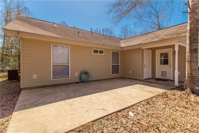 rear view of property with a patio area and central AC