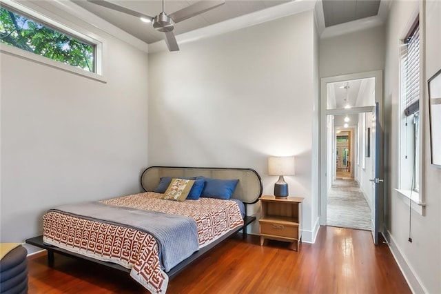 bedroom featuring baseboards and wood finished floors