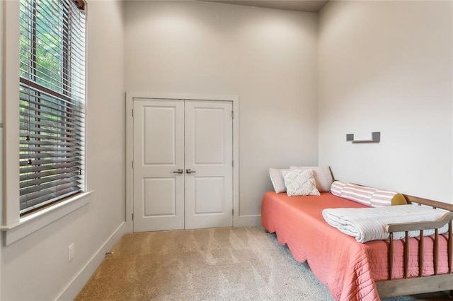 bedroom featuring carpet floors and baseboards