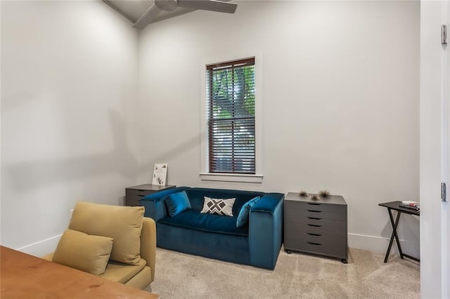 sitting room featuring baseboards, a ceiling fan, and carpet flooring