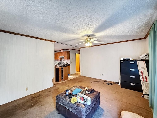 living area with ornamental molding, light carpet, a textured ceiling, and a ceiling fan