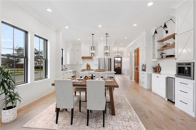 dining room featuring recessed lighting, baseboards, ornamental molding, light wood-type flooring, and an inviting chandelier