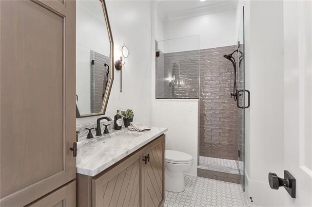 bathroom featuring vanity, tile patterned flooring, a shower stall, and toilet