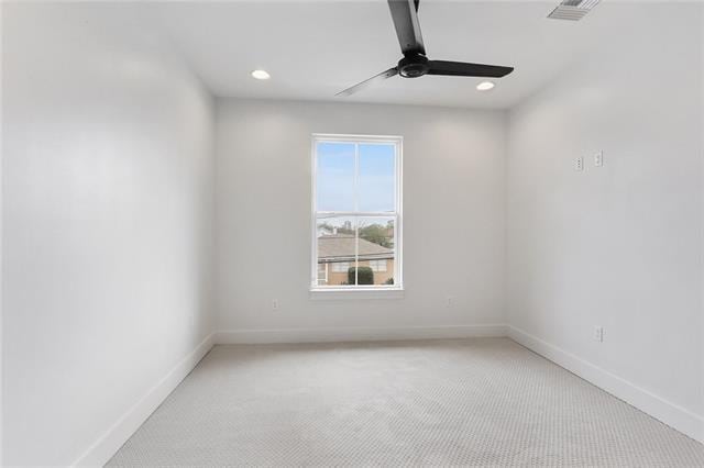 spare room with recessed lighting, light carpet, ceiling fan, and baseboards