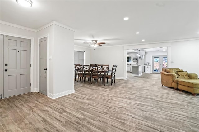 interior space featuring light wood-type flooring, baseboards, ornamental molding, and recessed lighting