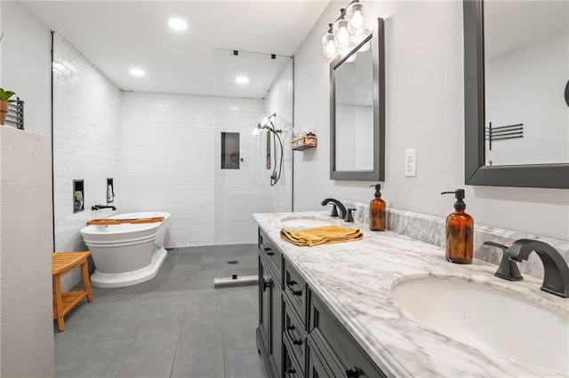 full bath featuring double vanity, a freestanding tub, walk in shower, and a sink