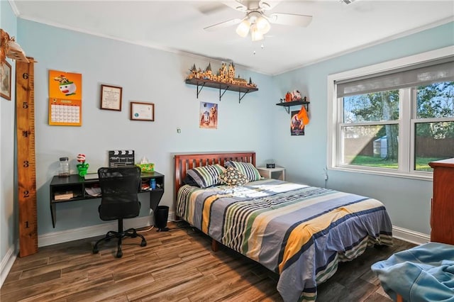 bedroom featuring ornamental molding, a ceiling fan, baseboards, and wood finished floors