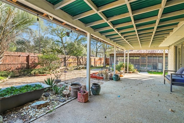 view of patio featuring a garden and a fenced backyard