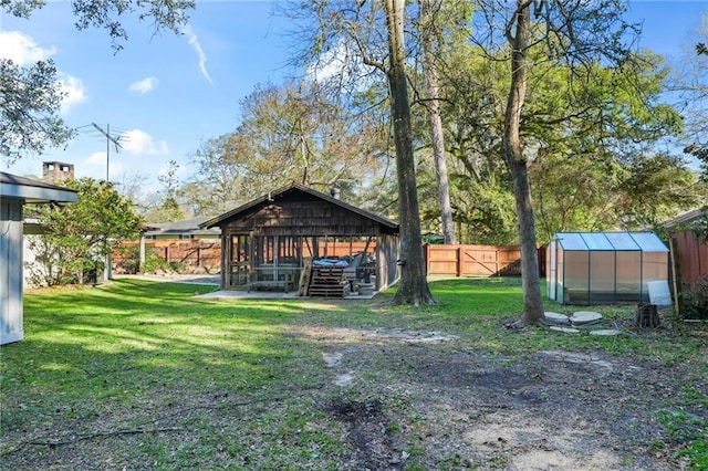 view of yard featuring a fenced backyard, an outdoor structure, and an exterior structure