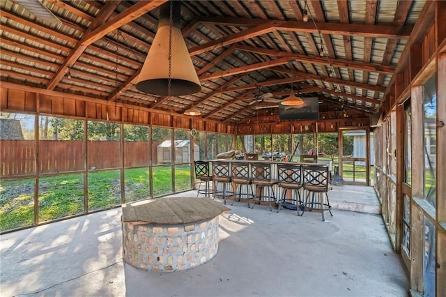 unfurnished sunroom featuring vaulted ceiling