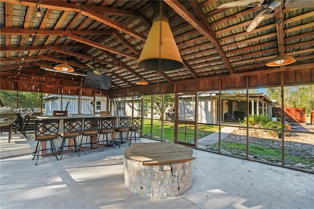 unfurnished sunroom featuring lofted ceiling