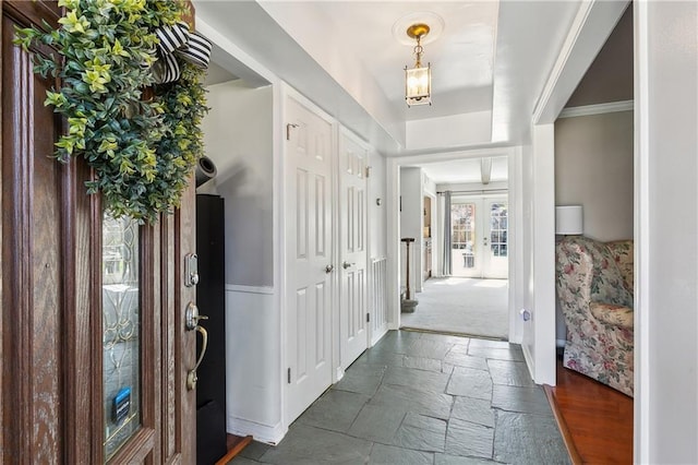 entryway with stone tile floors and french doors