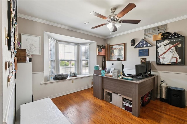 office area with ceiling fan, crown molding, baseboards, and wood finished floors