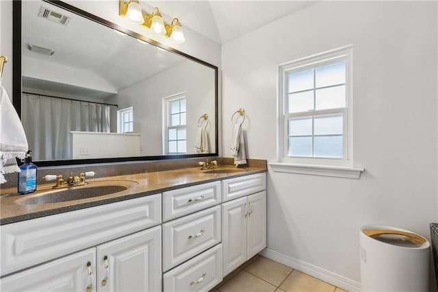 full bath featuring tile patterned flooring, plenty of natural light, a sink, and visible vents