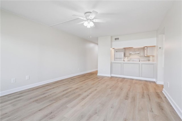 unfurnished living room featuring light wood-style floors, ceiling fan, visible vents, and baseboards