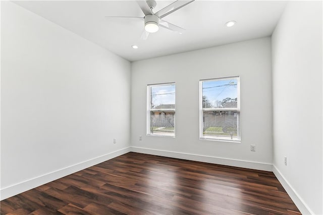 spare room featuring dark wood-type flooring, recessed lighting, a ceiling fan, and baseboards