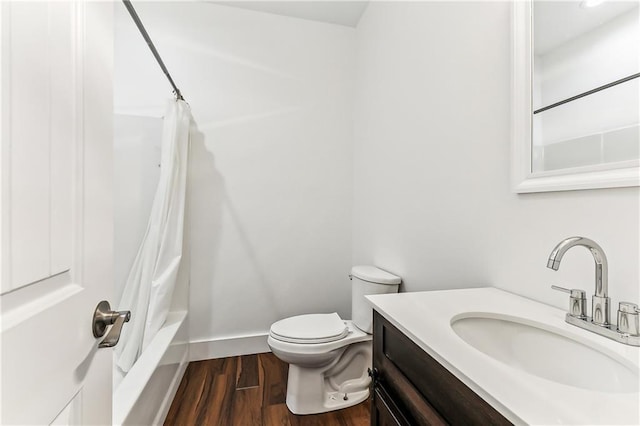 full bathroom with baseboards, vanity, toilet, and wood finished floors