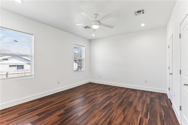 unfurnished bedroom featuring visible vents, baseboards, and multiple windows