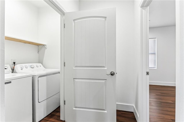 laundry area with laundry area, baseboards, separate washer and dryer, and dark wood finished floors