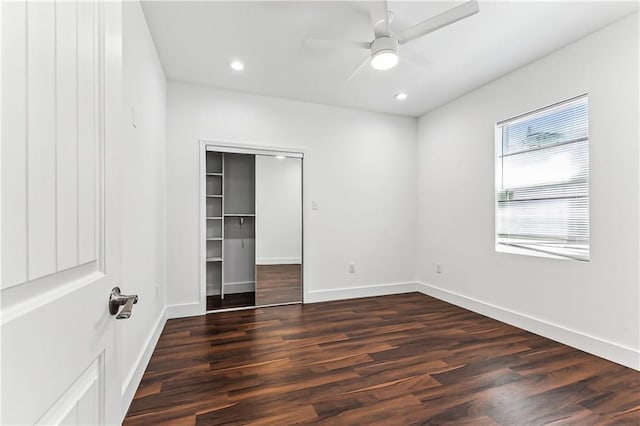 unfurnished bedroom featuring a closet, baseboards, wood finished floors, and recessed lighting