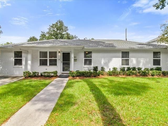 ranch-style home with a front lawn