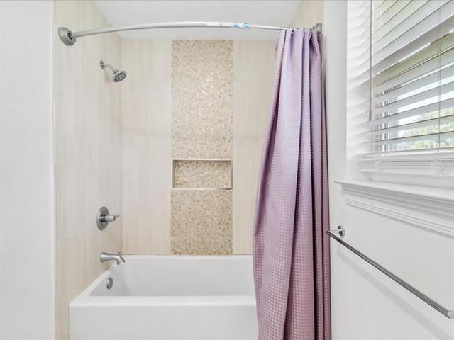 full bath featuring shower / tub combo with curtain