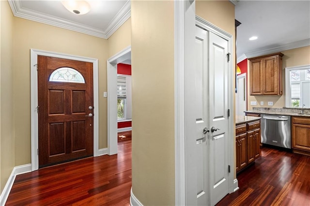 foyer featuring baseboards, ornamental molding, and dark wood finished floors