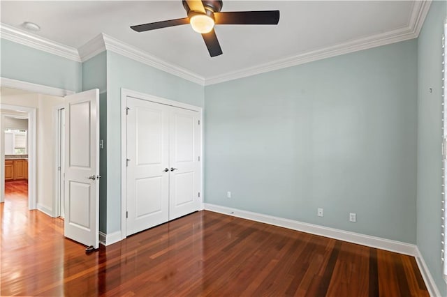 unfurnished bedroom with baseboards, wood finished floors, and crown molding