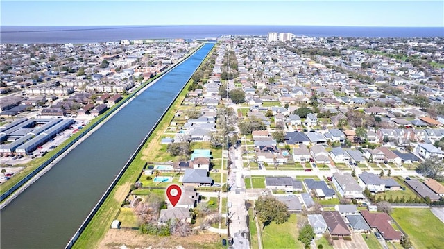 birds eye view of property featuring a water view and a residential view