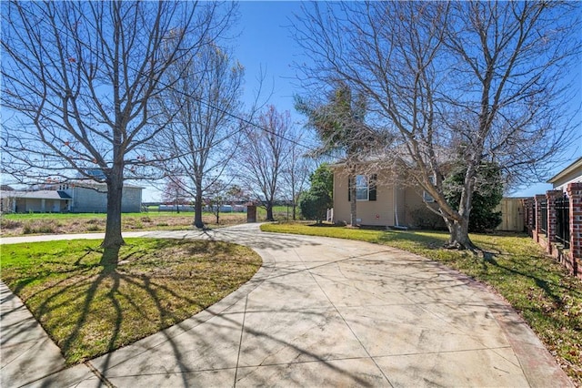 view of street featuring concrete driveway