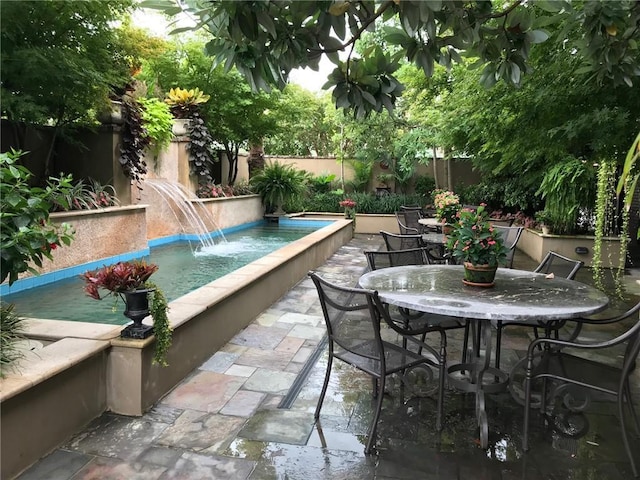 view of pool featuring a fenced in pool, outdoor dining space, a patio area, and a fenced backyard