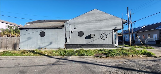 view of home's exterior with fence