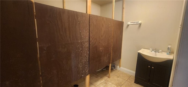 full bath featuring a walk in shower, tile patterned flooring, and vanity